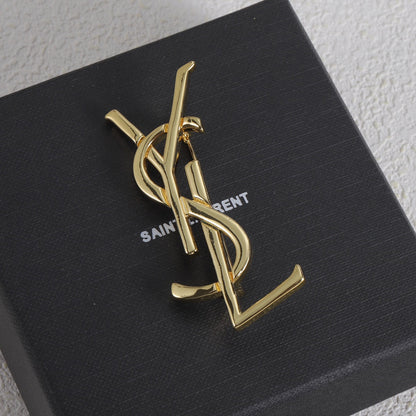 Shiny letter brooch